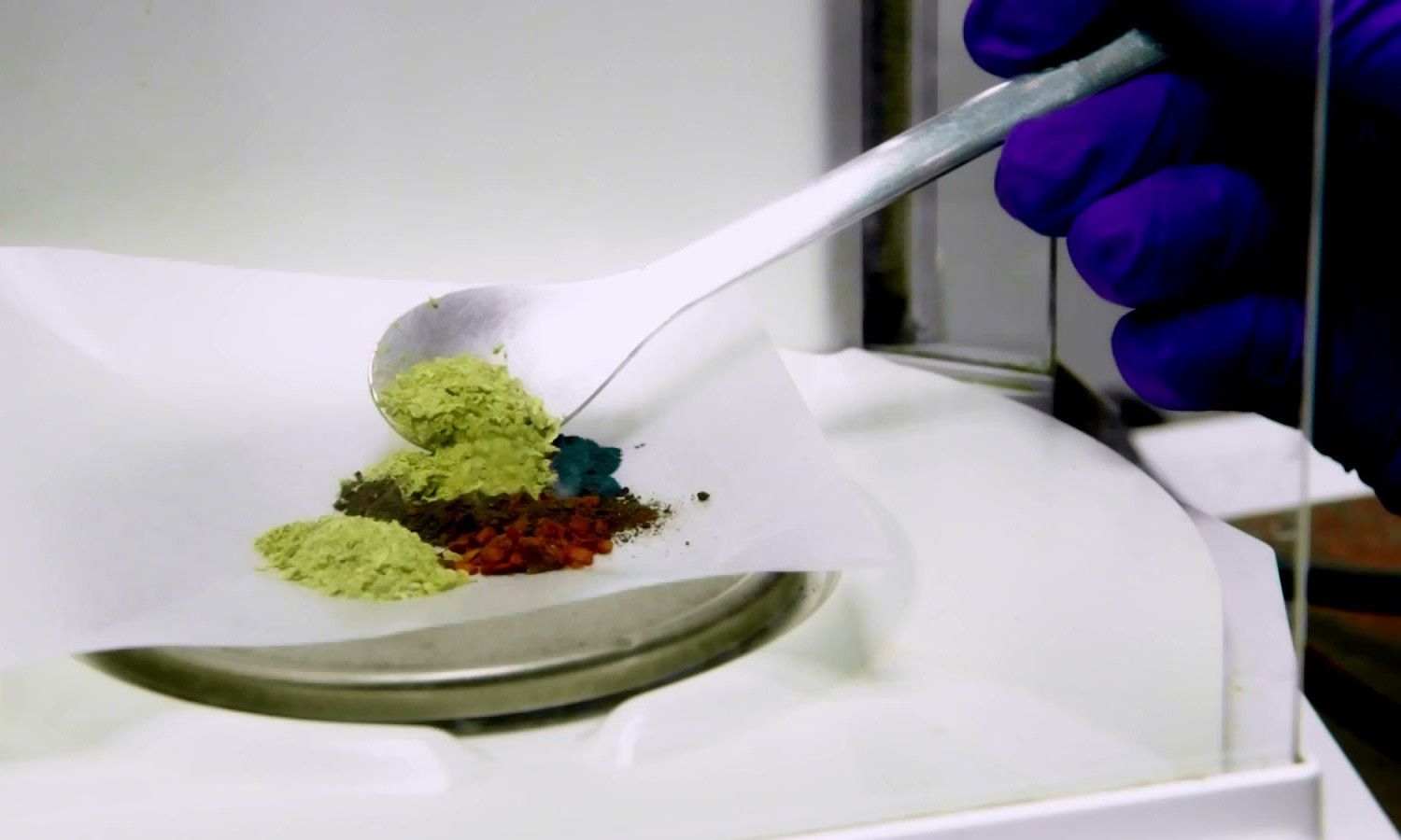 Botanical powders being weighed on a lab balance